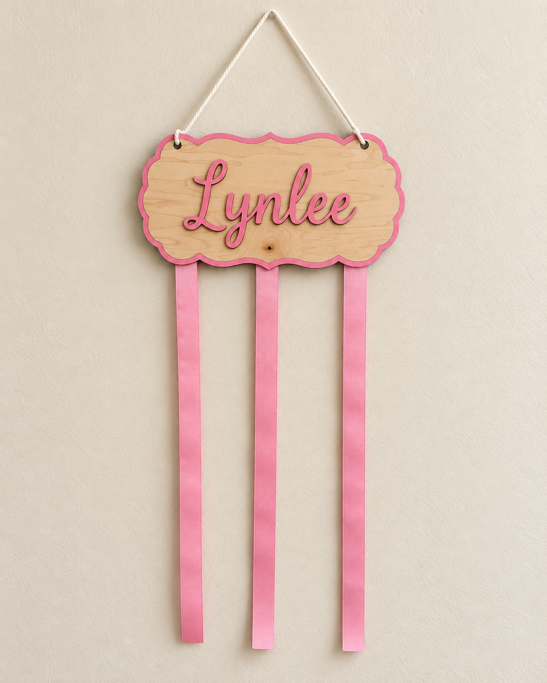 Empty personalized maple bow holder with three pink ribbon strands