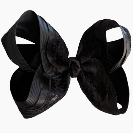 Black bow hair accessory on a white background