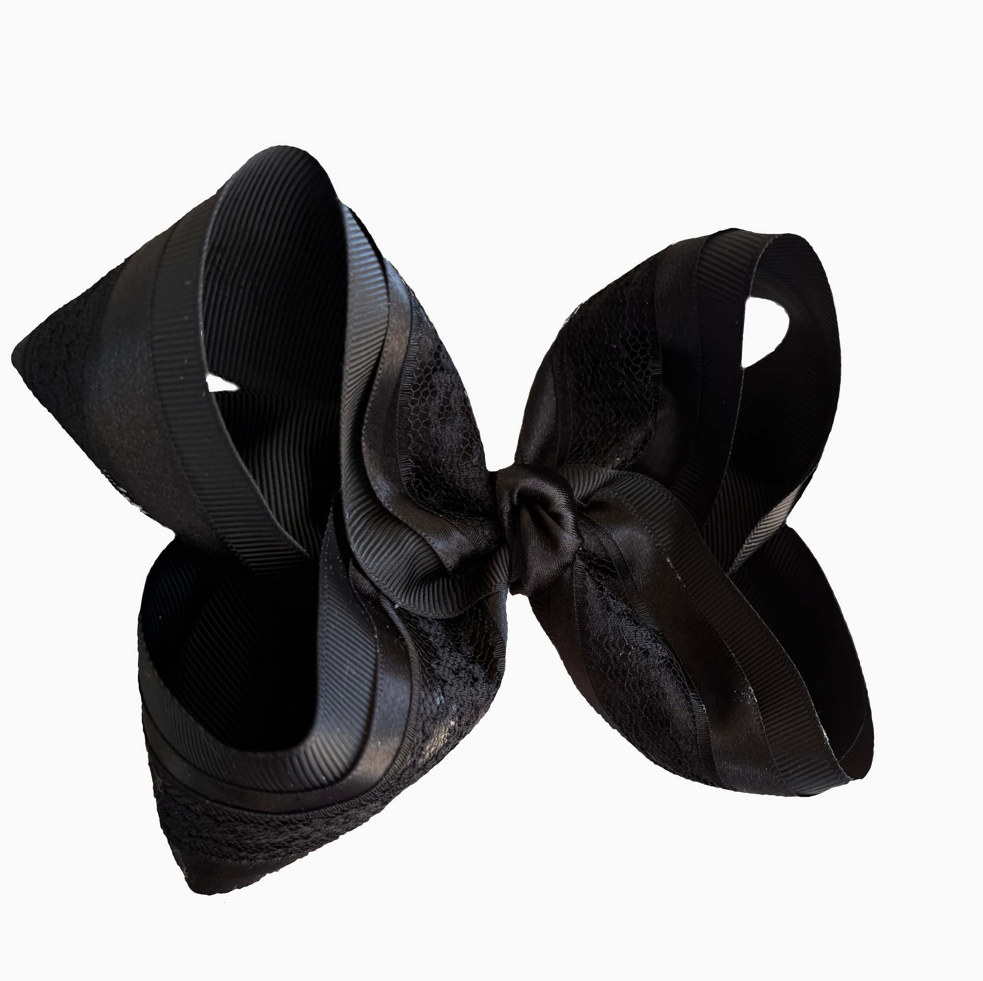 Black satin hair bow on a white background