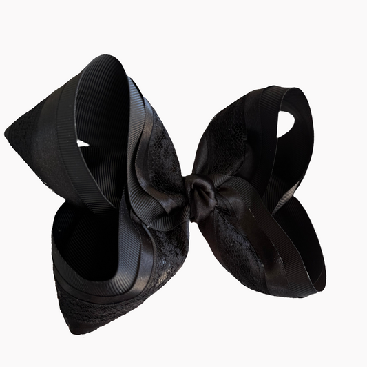 Black satin hair bow on a white background
