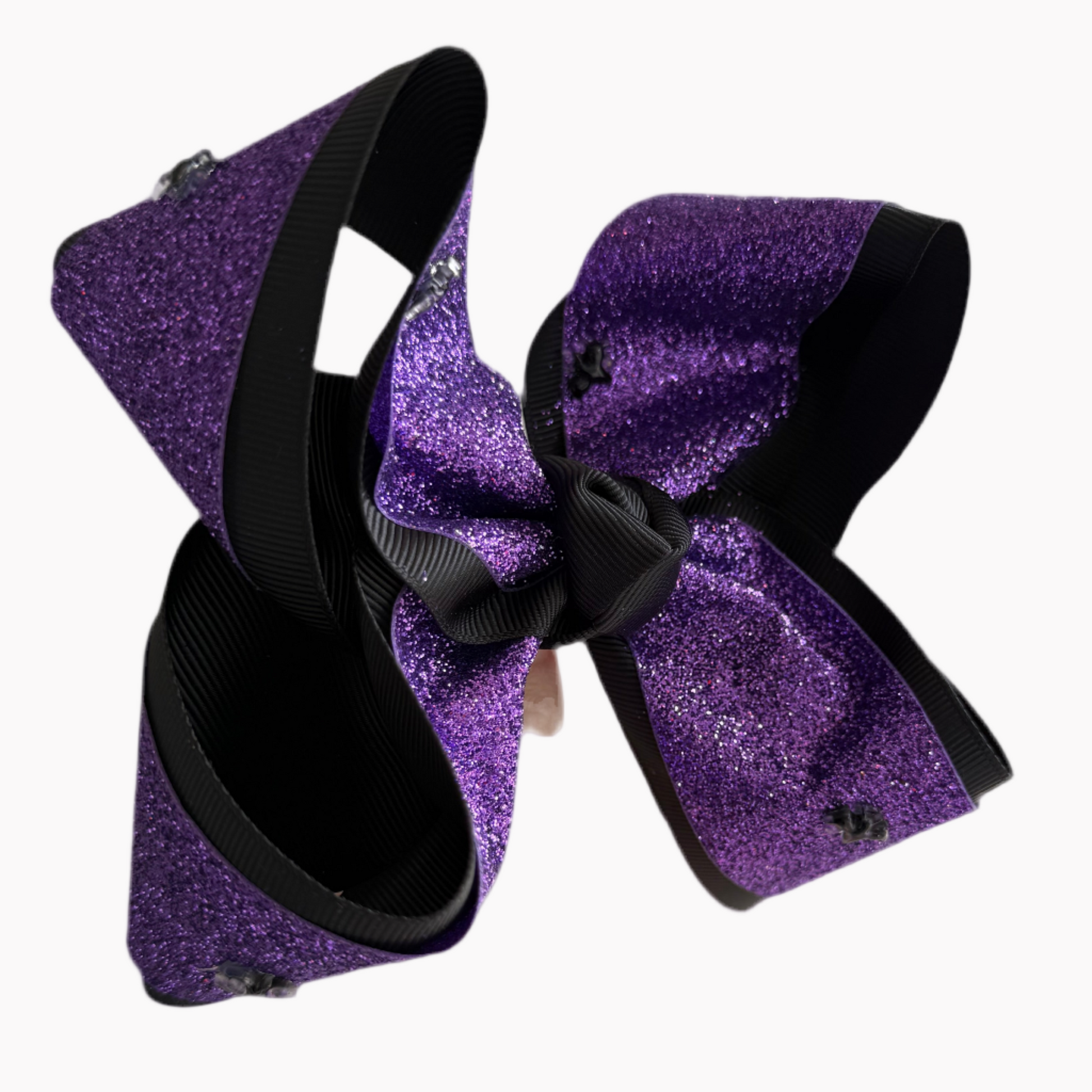 Purple glittery hair bow with black ribbon on a white background