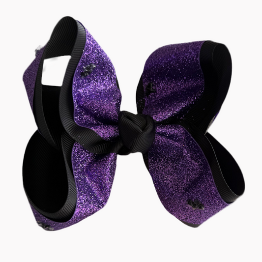 Purple glittery hair bow with black hair ties on a white background
