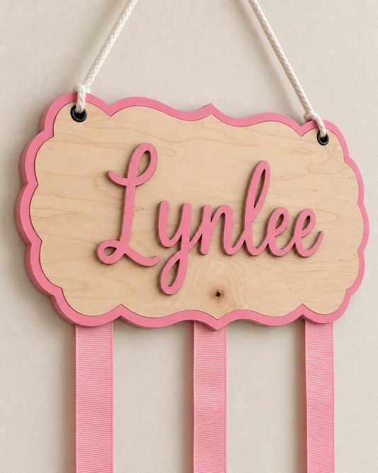 Close-up of raised pink name and layered maple bow holder construction
