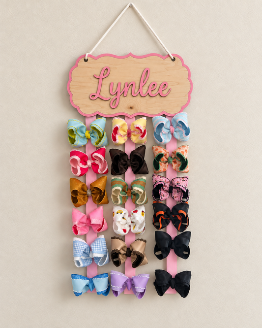 Personalized maple bow holder filled with large boutique bows on three spaced ribbons